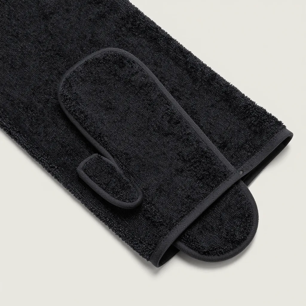 A black coarse-weave Italy towel mitt on a light background